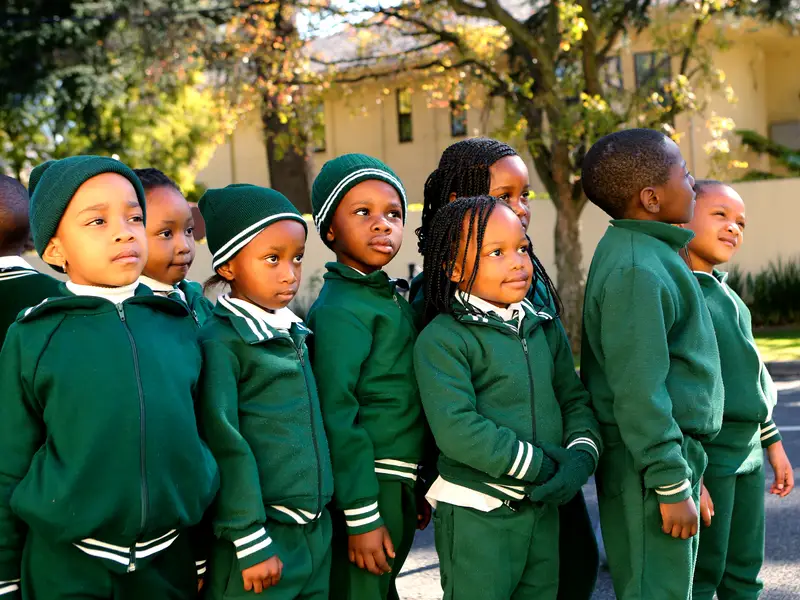 Young learners wearing locally supplied green school uniforms